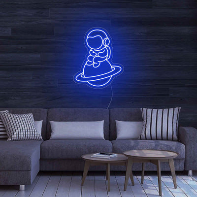 Astronaut Sitting On Planet Neon Sign